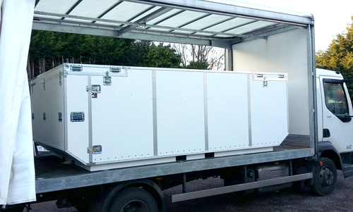 Massive white flight case at the back of a truck holding Formula E car