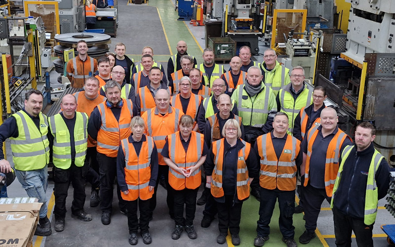 Penn Elcom Washington, UK group photo in the warehouse 